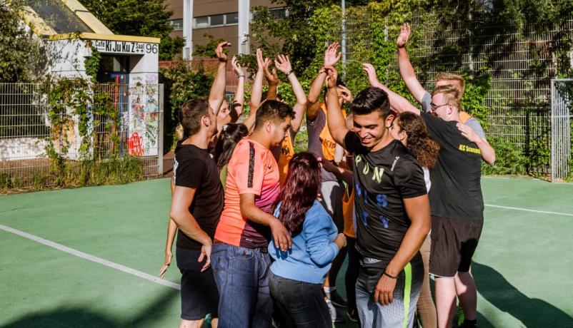 Jugendliche beim Spiel auf einem Sportplatz